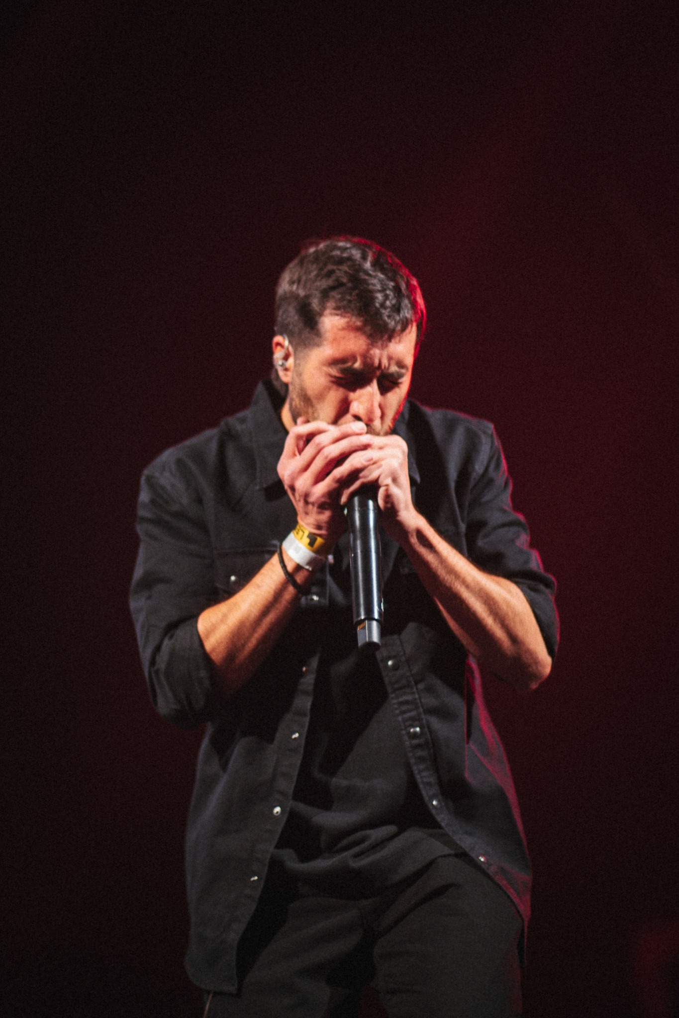 Nicolás Rivas playing harmonica on stage